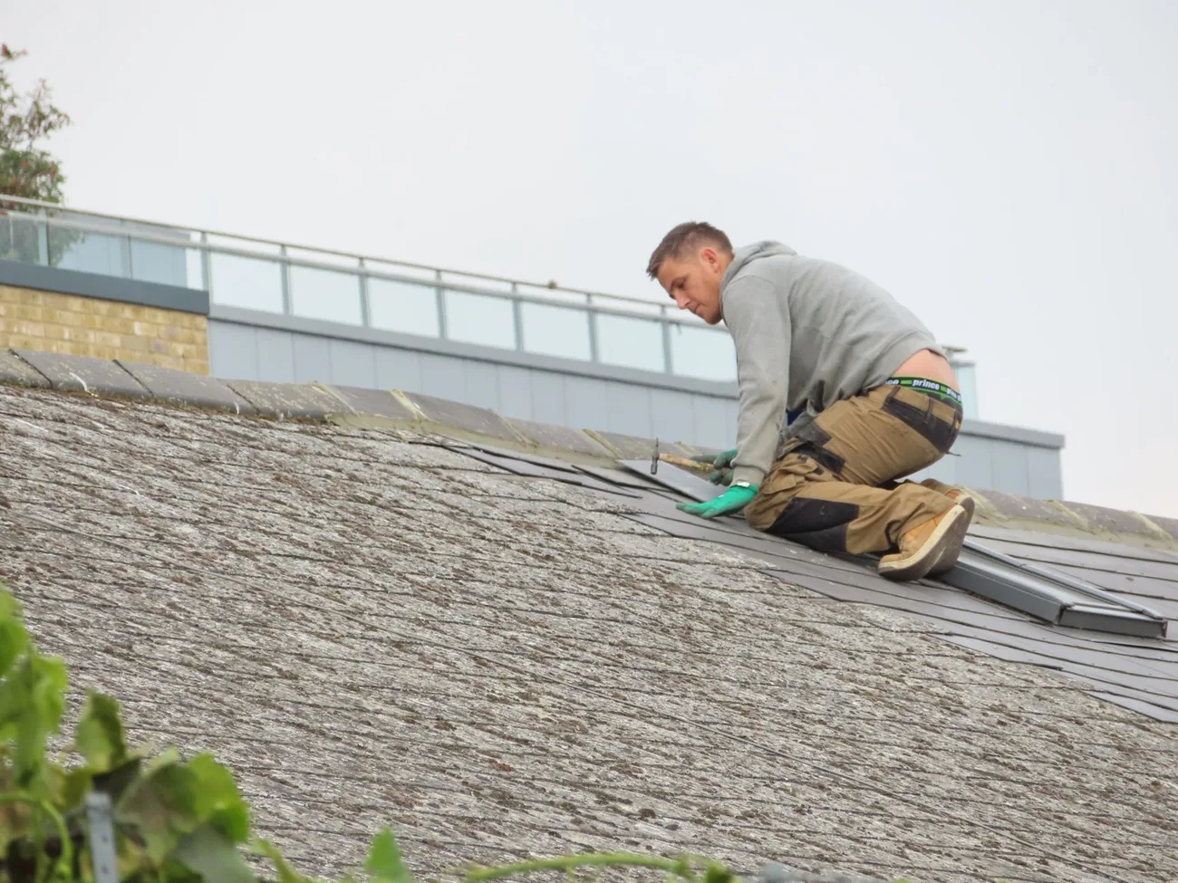 Operative inspecting a roof surface up close